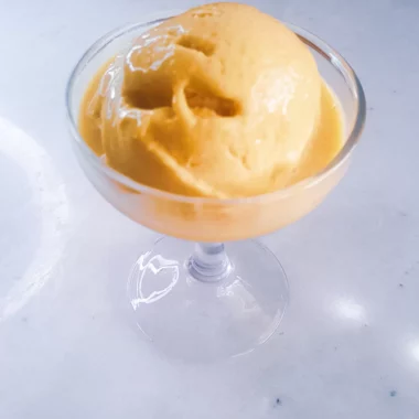 Vegan mango Ice cream in a dessert glass.