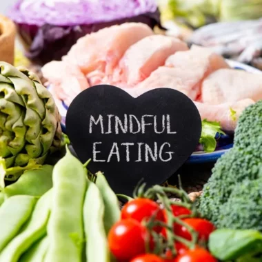 Chicken, artichoke, cherry tomatoes, snap peas, broccoli, and nuts with a sign that says mindful eating