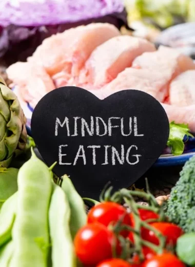 Chicken, artichoke, cherry tomatoes, snap peas, broccoli, and nuts with a sign that says mindful eating