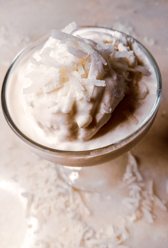 jelly coconut ice cream in a glass with shredded coconut