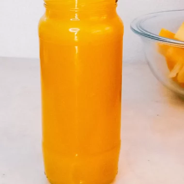Homemade pumpkin puree in a jar and fresh diced pumpkin.