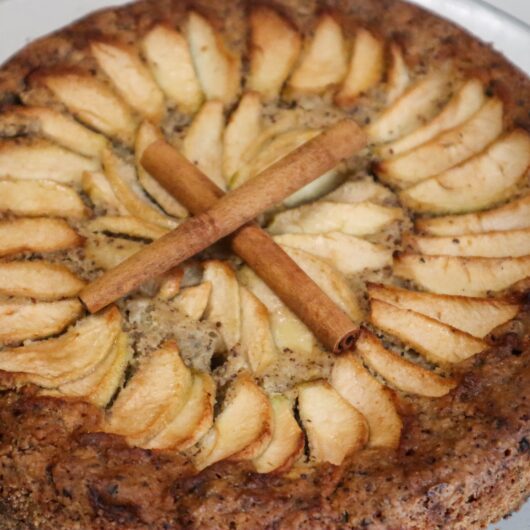 Hazelnut apple zucchini cake on a cake stand.