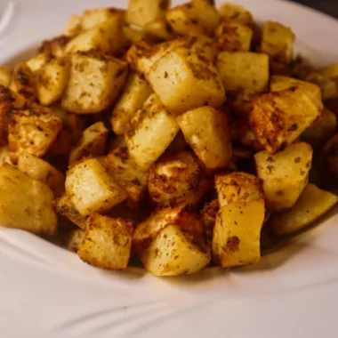 Air fryer garlic parmesan potatoes in a bowl.
