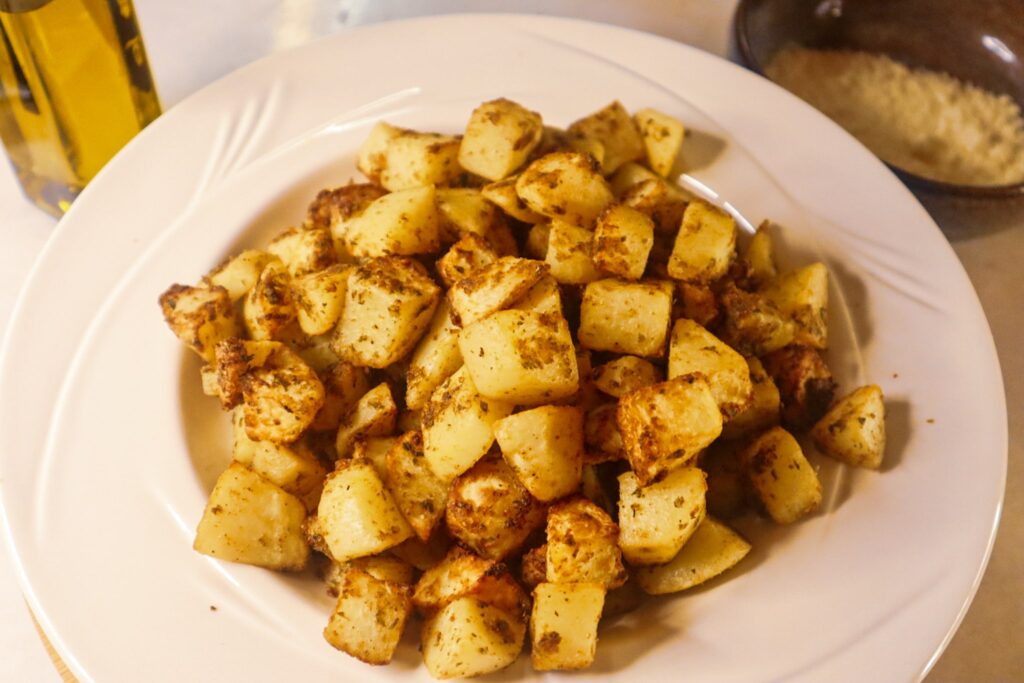 Air fryer garlic parmesan potatoes in a bowl.
