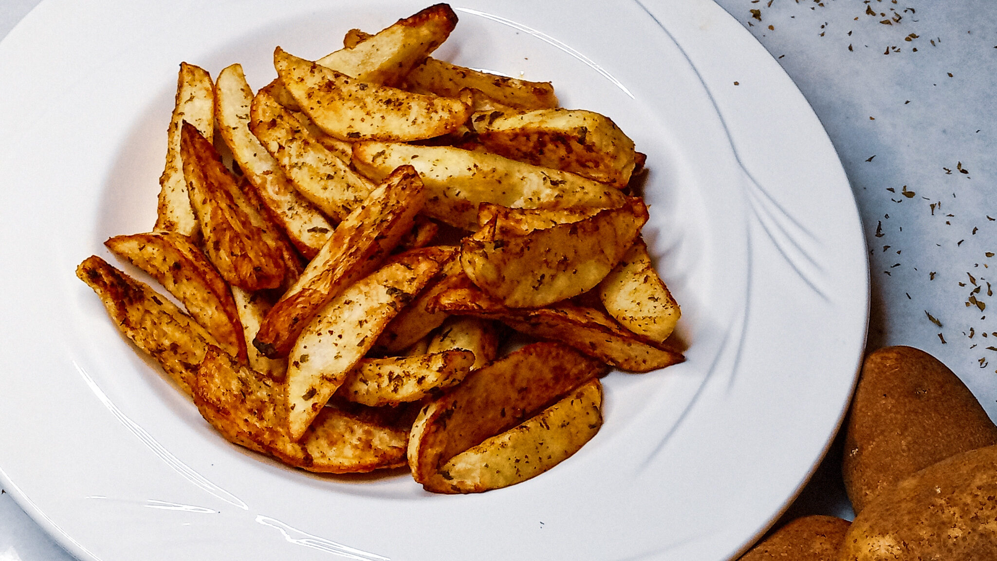 Air fryer potato wedges in a bowl