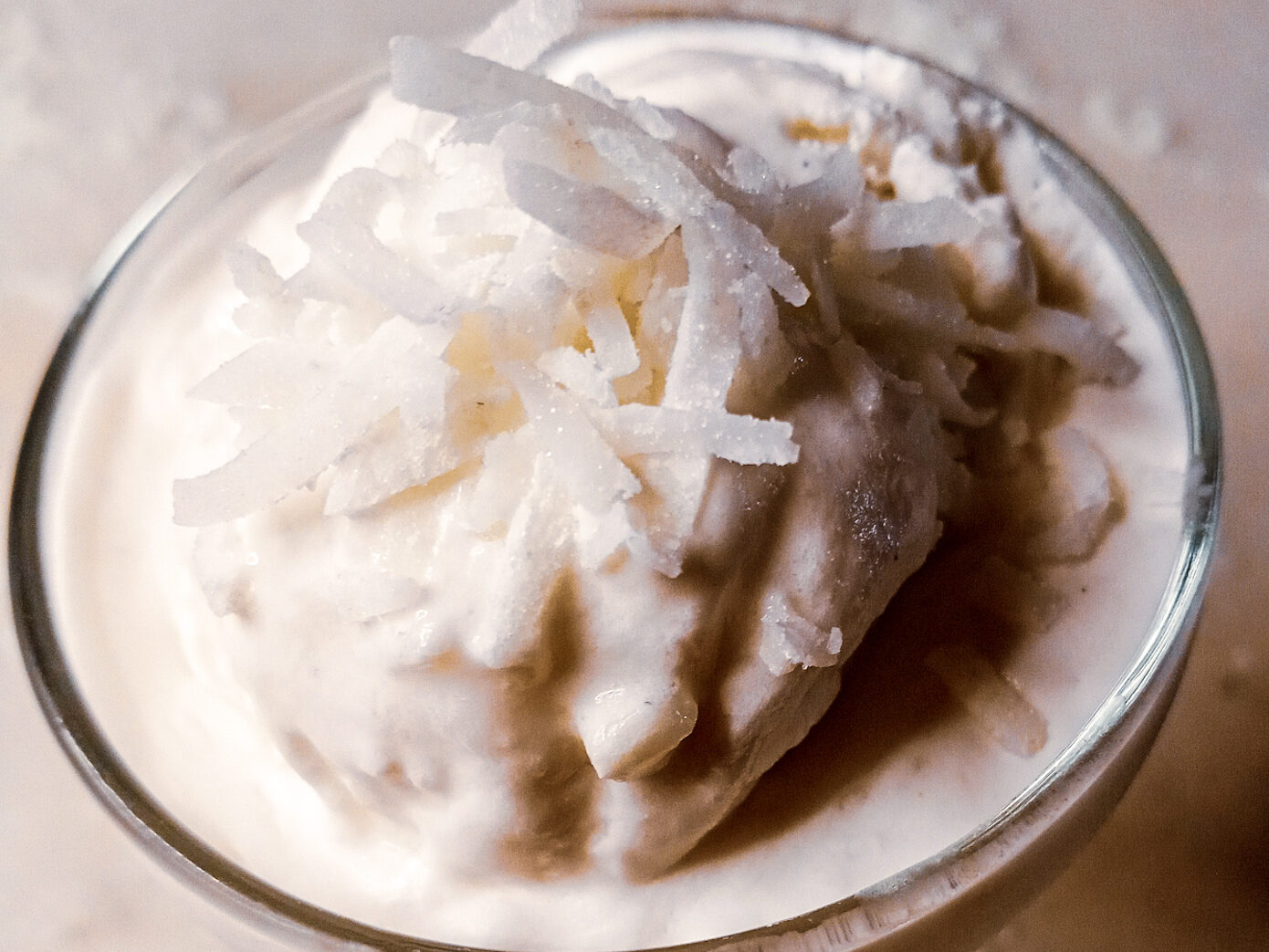 jelly coconut ice cream in a glass with shredded coconut