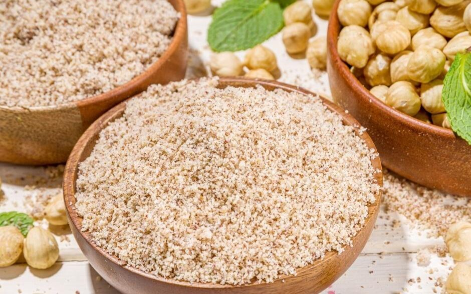 Hazelnut flour and hazelnuts in bowls