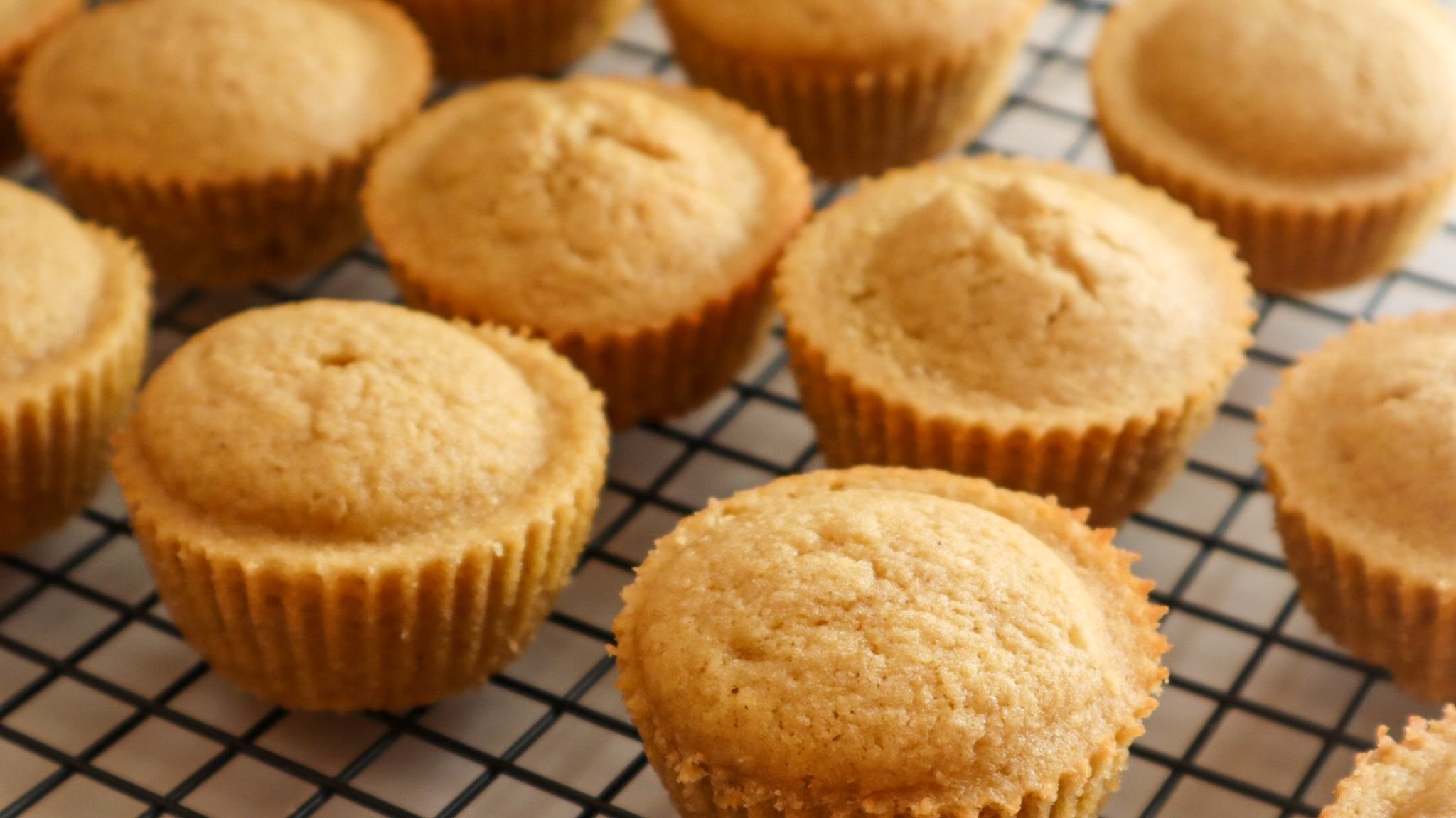 Maple cornbread muffins gluten-free on a cooling rack.