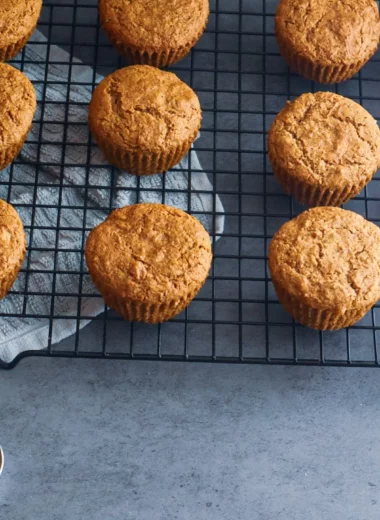 Paleo carrot cake muffins on a cooling rack.