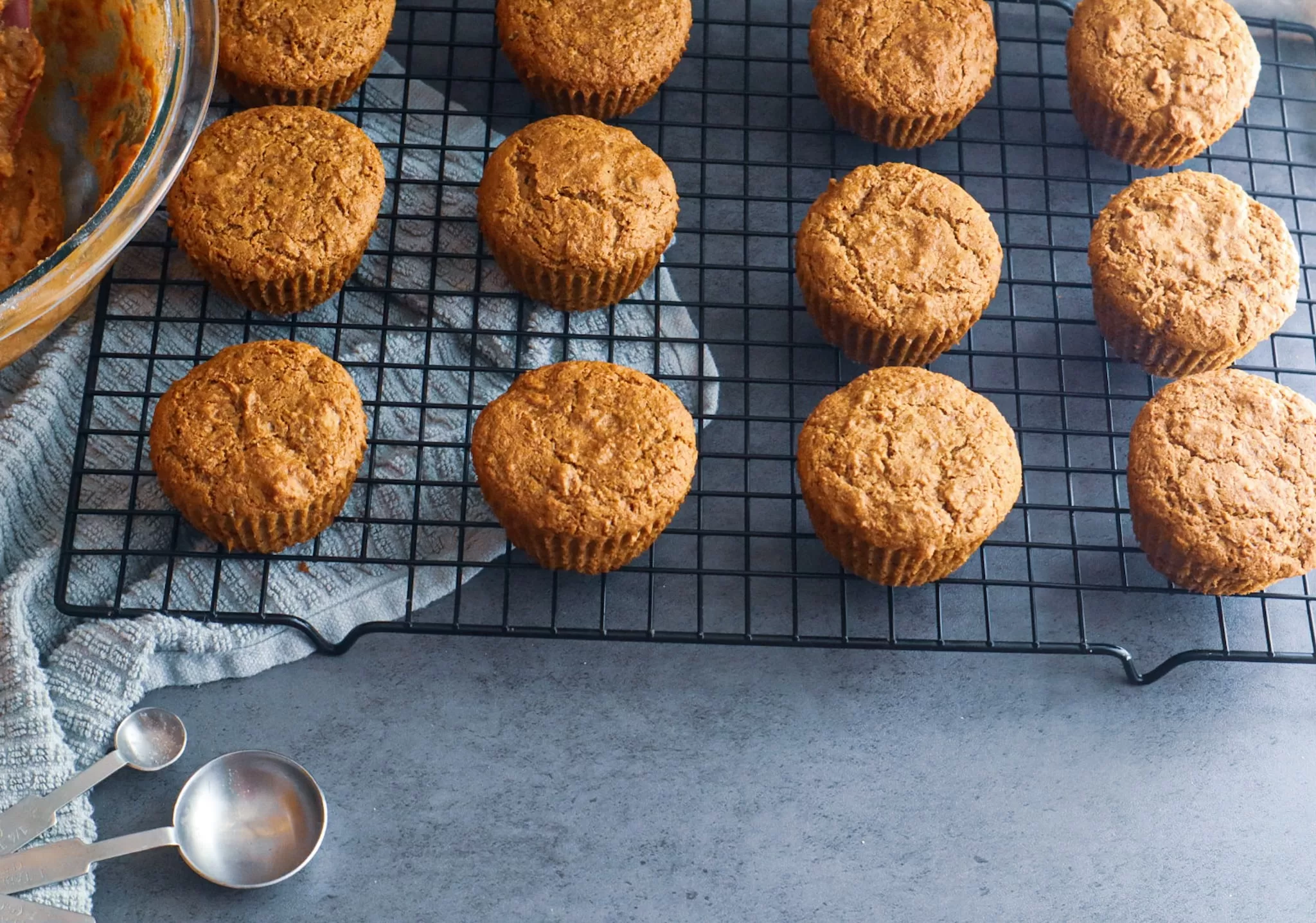 Paleo carrot cake muffins on a cooling rack.