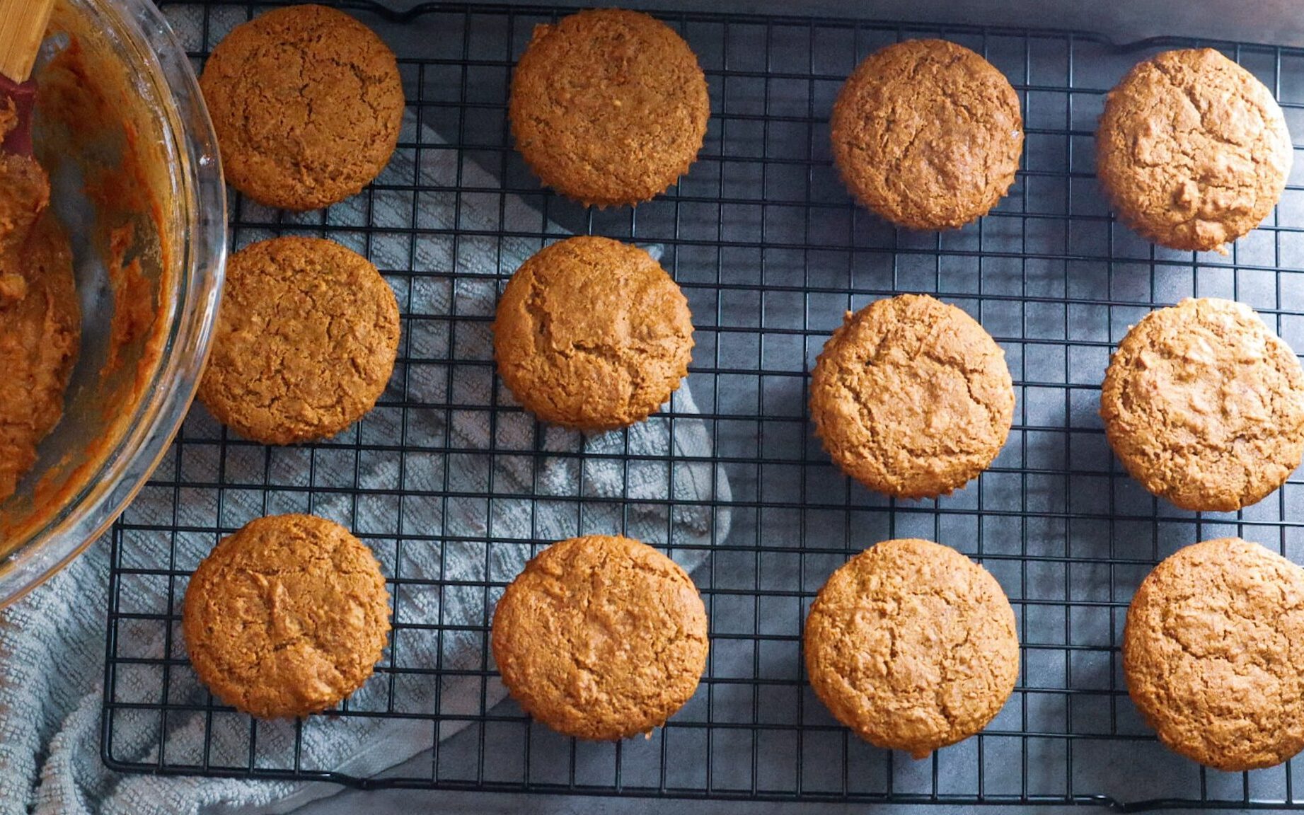 Paleo carrot cake muffins on a cooling rack.