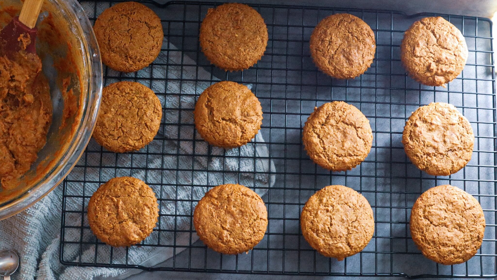 Paleo carrot cake muffins on a cooling rack.