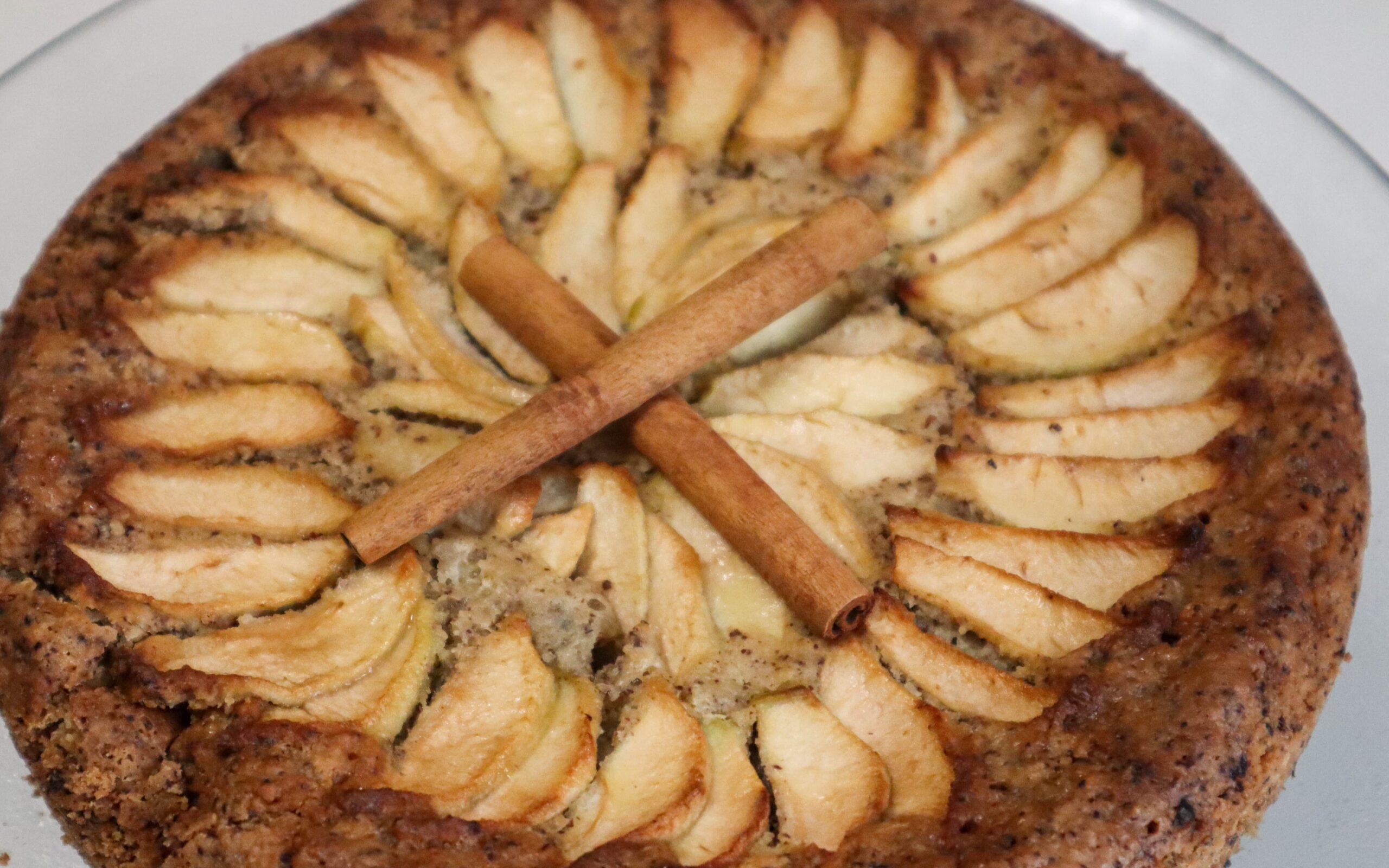 Hazelnut apple zucchini cake on a cake stand.