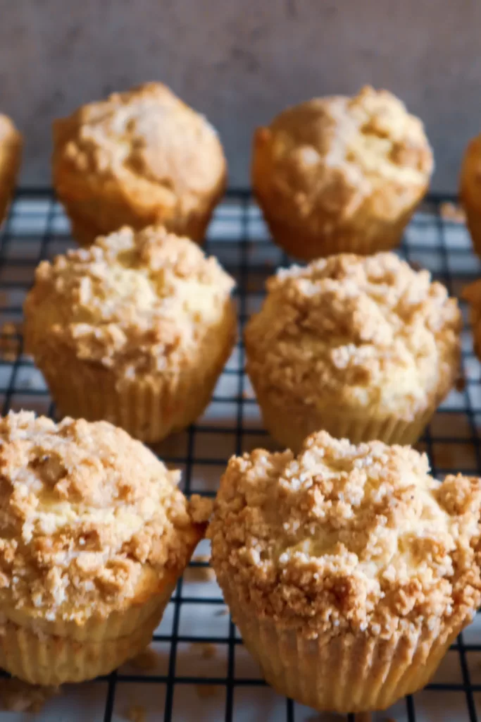 Gluten-free coffee cake muffins on a cooling rack.