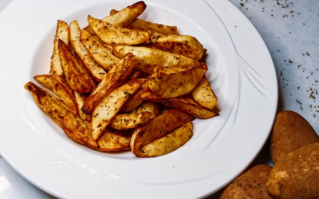 Air fryer potato wedges in a bowl