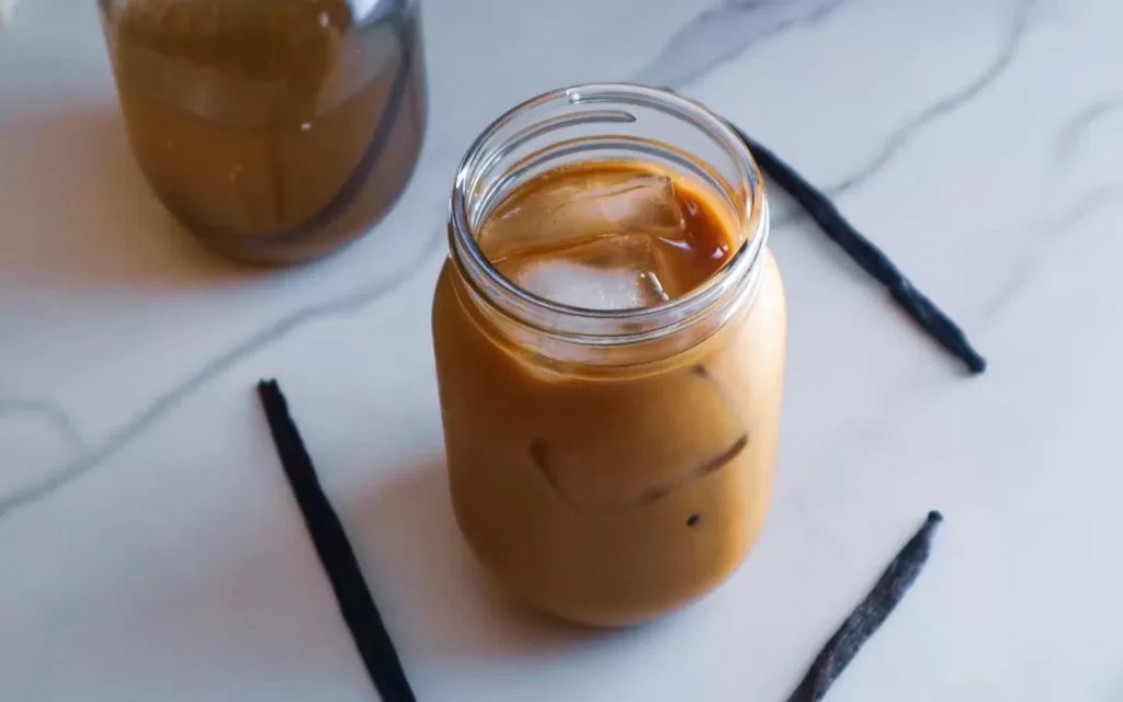 Iced oat milk vanilla latte in a mason jar.