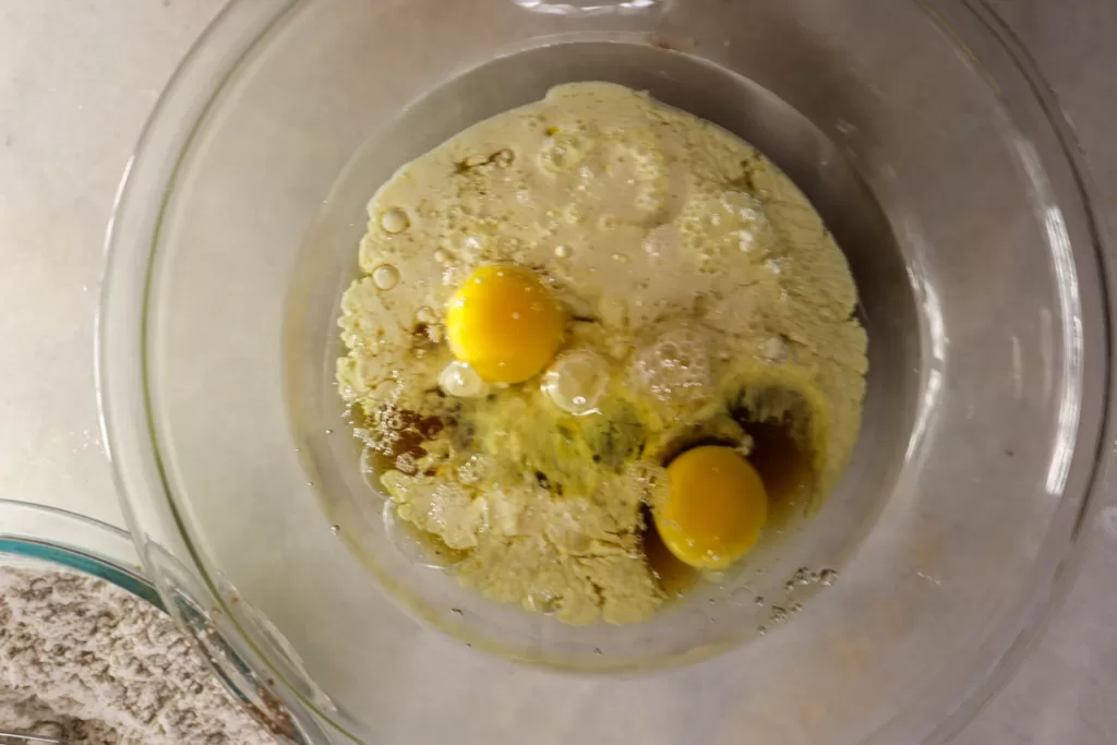 Wet ingredients for maple crunch muffins in a bowl.