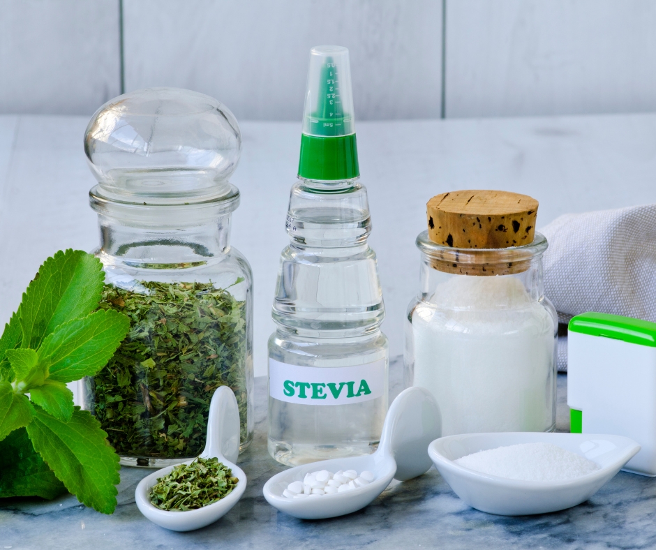 Stevia drops, stevia leaves, and stevia powder on a counter top.