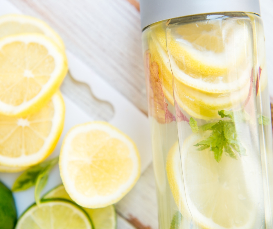 Water infused with fresh herbs and lemon slices,