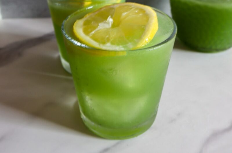 Refreshing coconut cucumber water in 2 glasses garnished with lime.