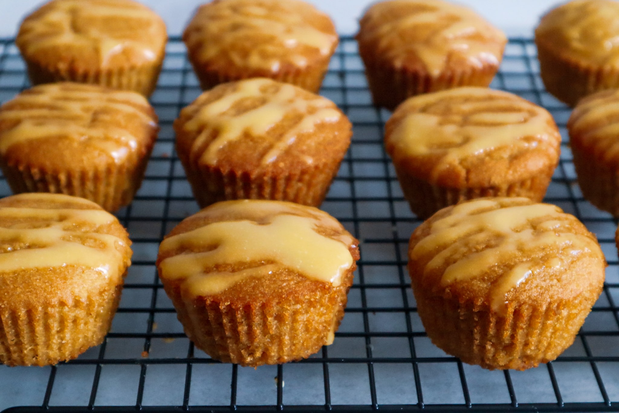 Gluten-free mango muffins on a cooling rack.