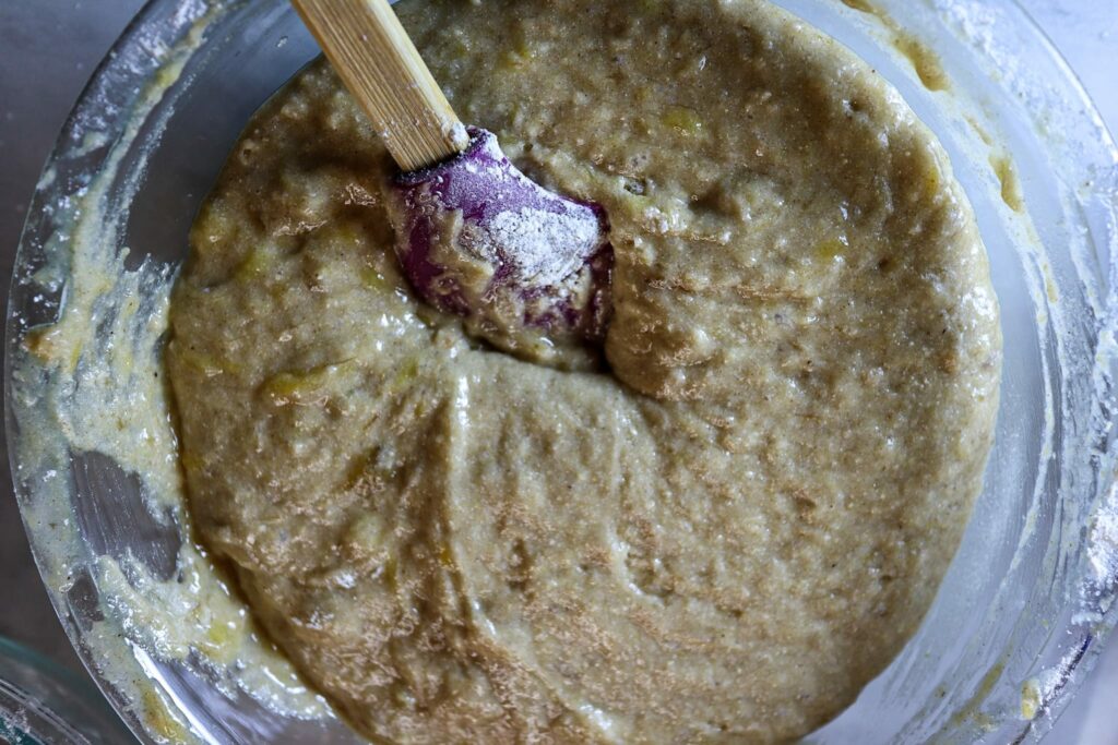 Gluten-free banana bread batter in a mixing bowl.