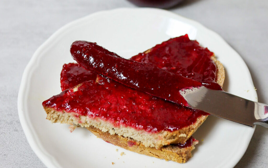 Cranberry jam spread on sourdough bread.