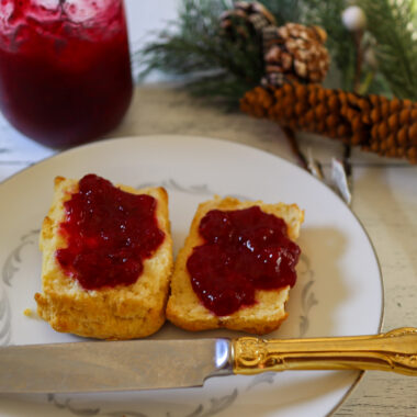 Cranberry jam spread on gluten-free biscuits.