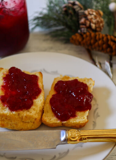 Cranberry jam spread on gluten-free biscuits.