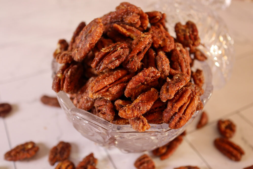 Spiced candied pecans in a serving dish.