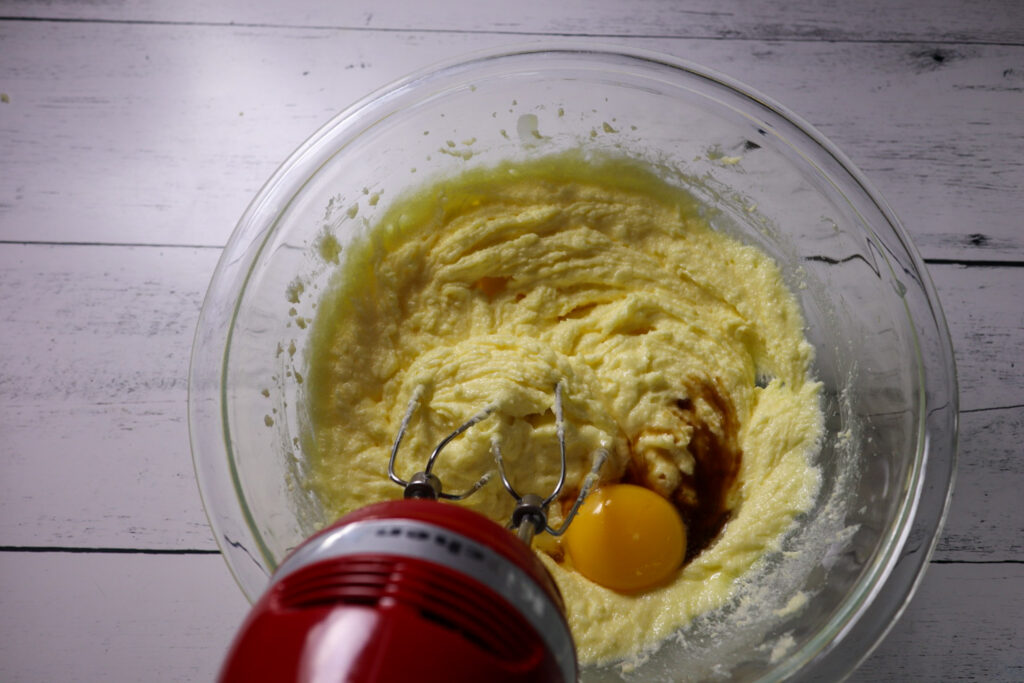 Mixing in the egg, egg yolk, and vanilla extract.