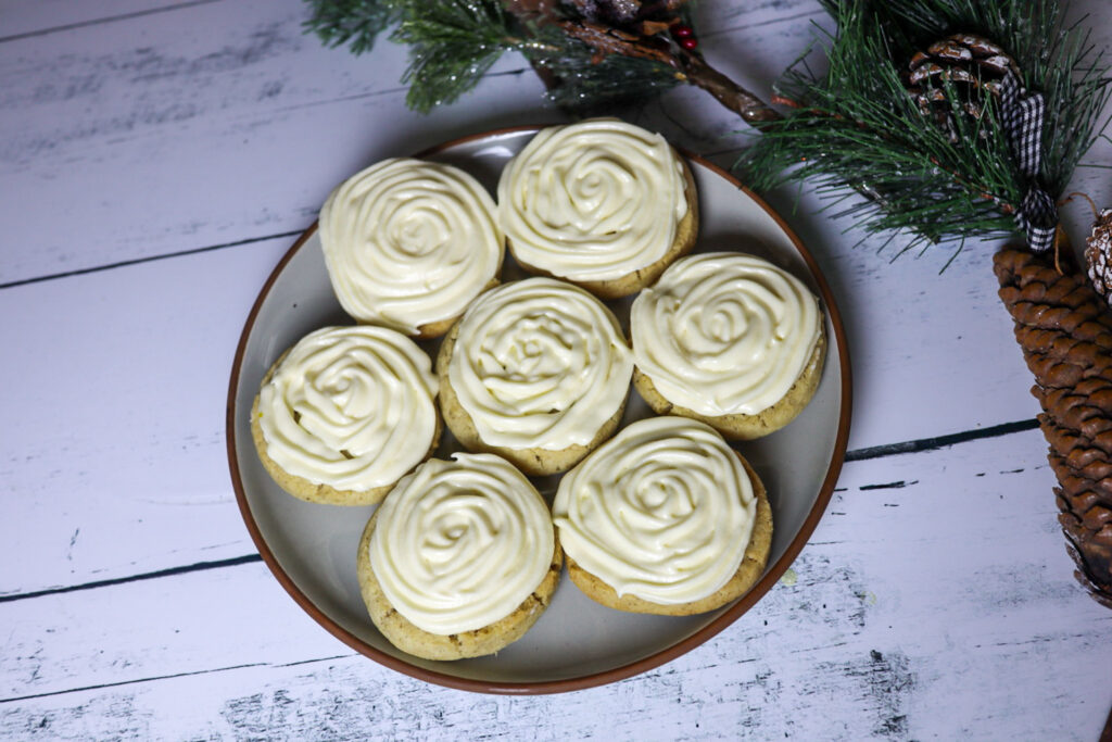 Gluten-free vanilla icebox sugar cookies with cream cheese frosting on a plate.