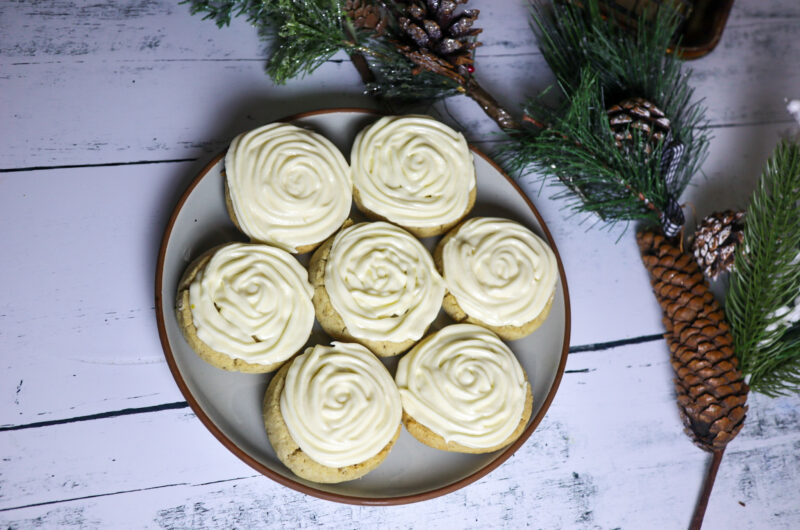 Gluten-free icebox vanilla sugar cookies with cream cheese frosting on a plate.