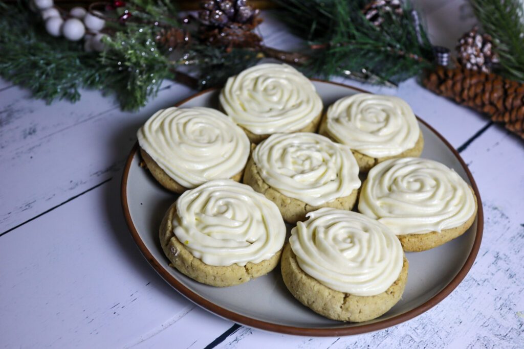 Icebox vanilla sugar cookies with cream cheese frosting on a plate.