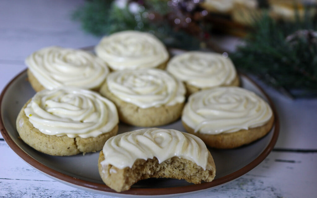 Gluten-free icebox vanilla sugar cookies with cream cheese frosting on a plate.