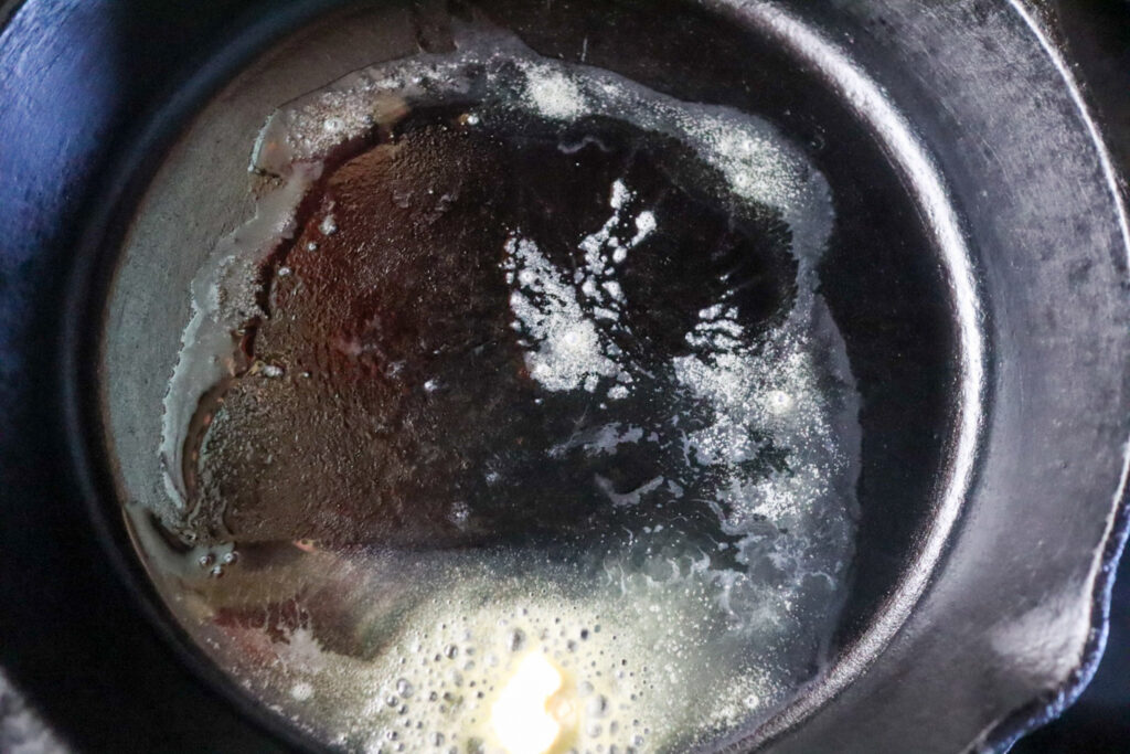 Melting the butter in a skillet.