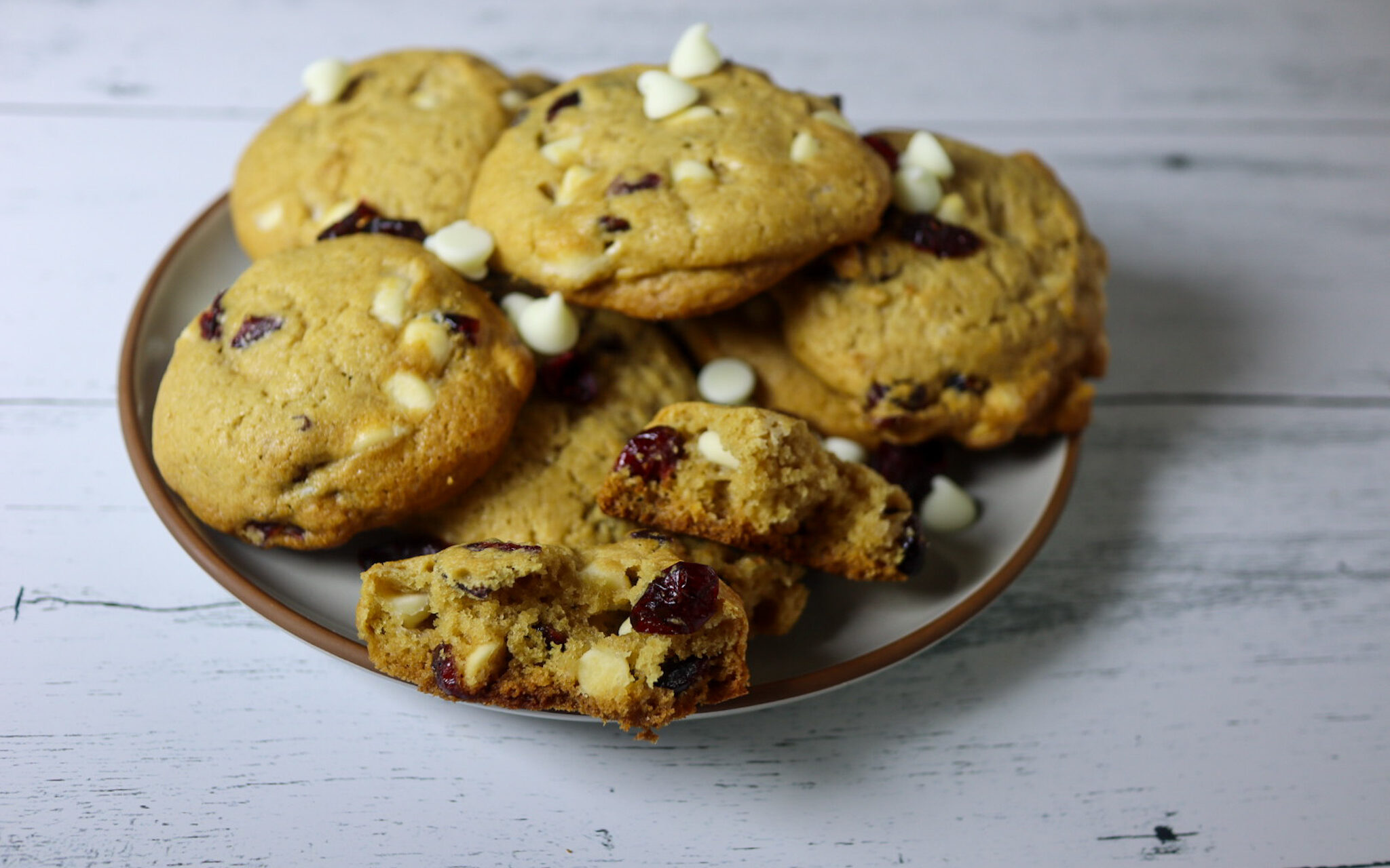 Gluten-free cranberry white chocolate chip cookies on on a plate.