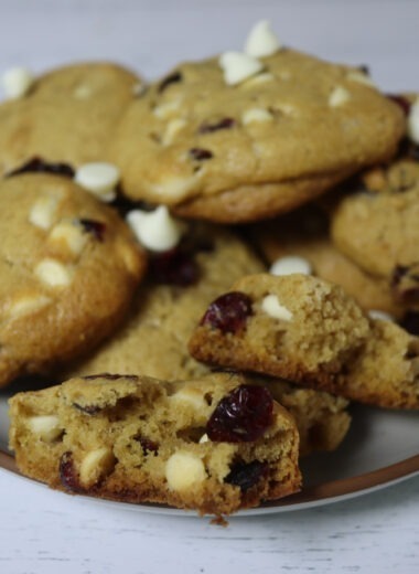 Gluten-free cranberry white chocolate chip cookies on on a plate.