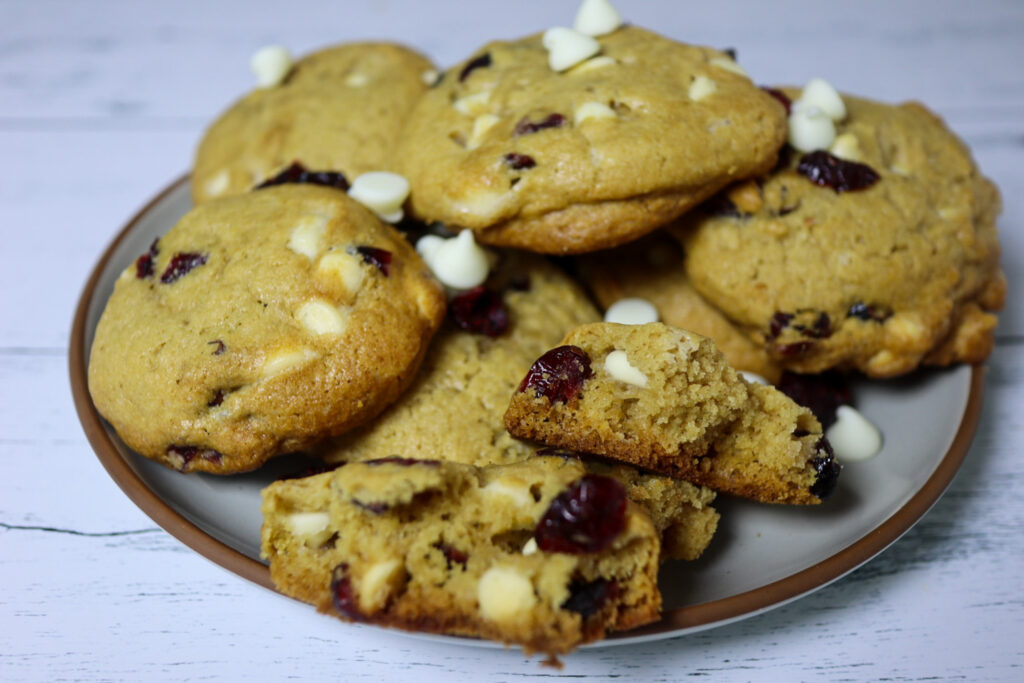 Gluten-free cranberry white chocolate chip cookies on on a plate.