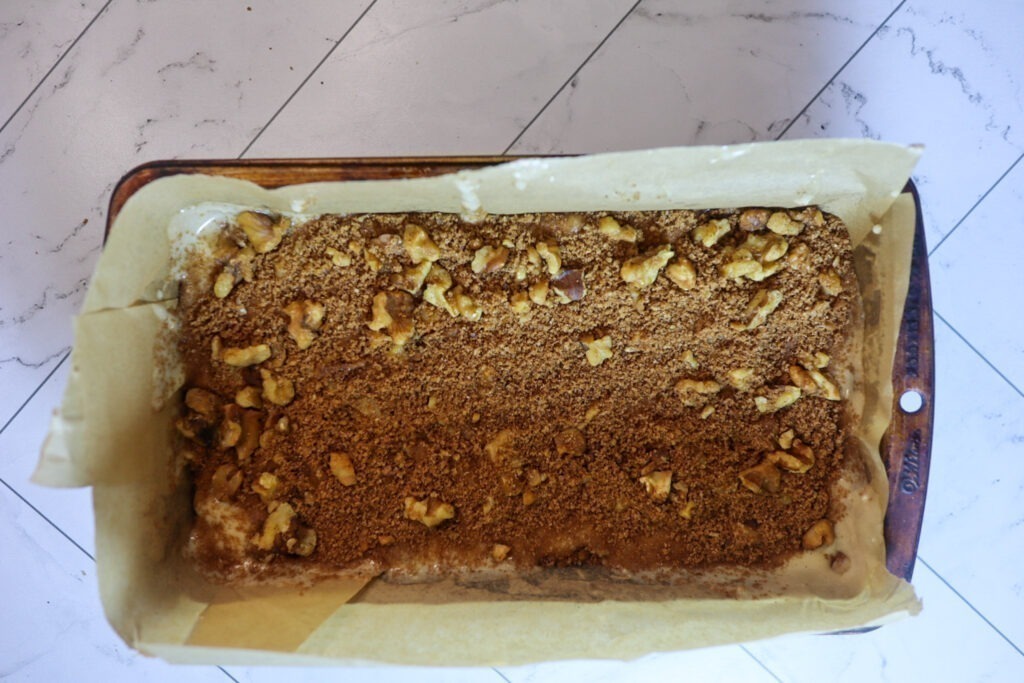 Sprinkling the topping on top of the bread.