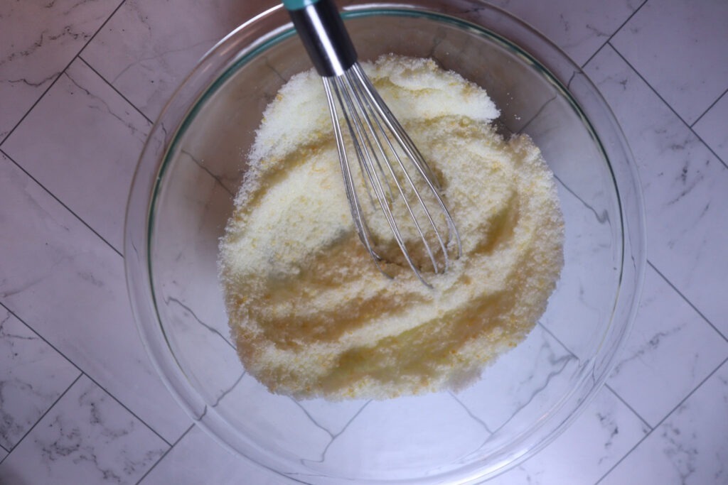 Whisking the monk fruit sweetener and orange zest together.
