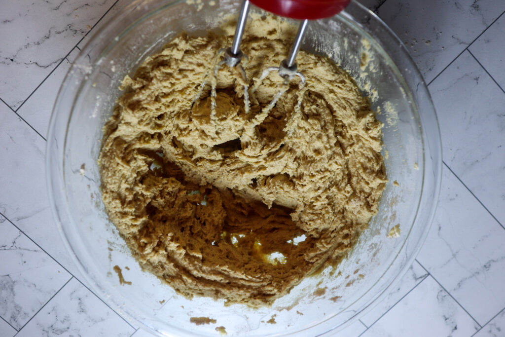 Mixing the dry ingredients into the cookie dough.
