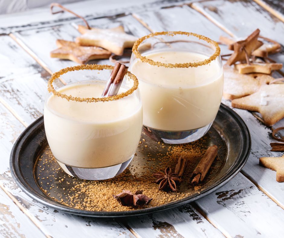 Eggnog in glasses garnished with spices. 