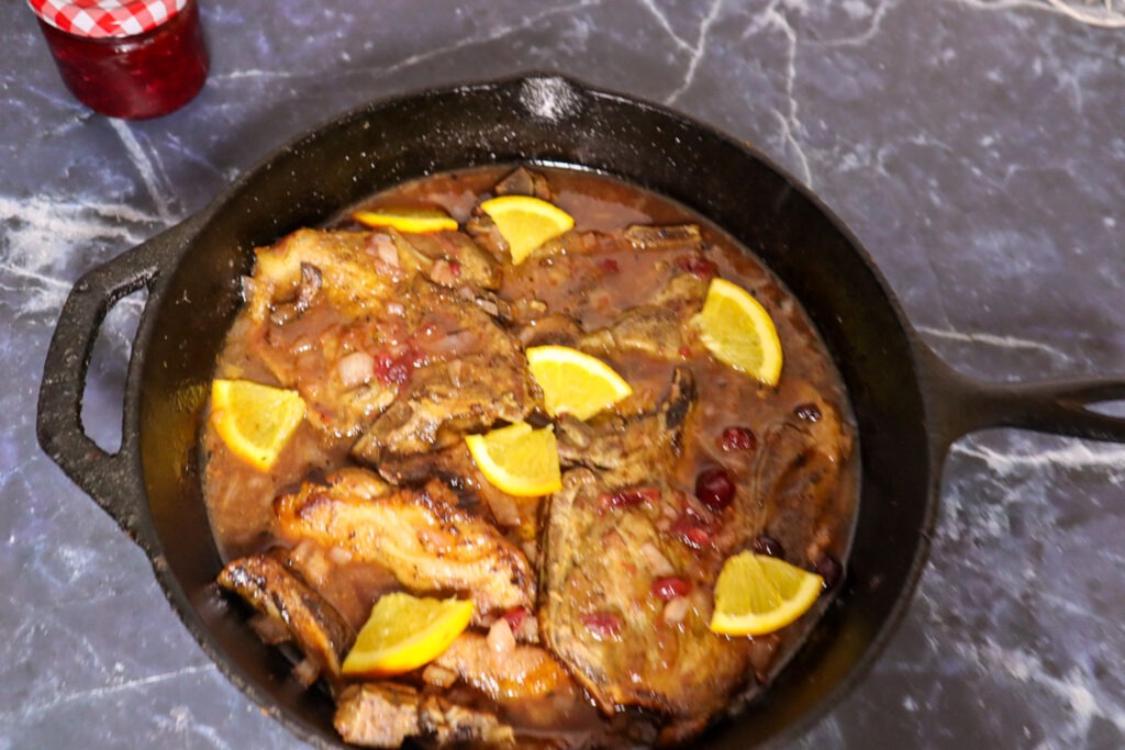 Cranberry pork chops in a skillet