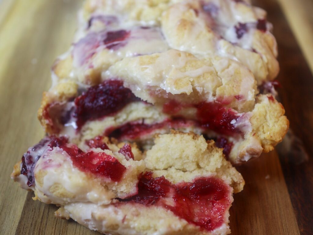 Gluten-free cranberry jam pull-apart bread on a cutting board.