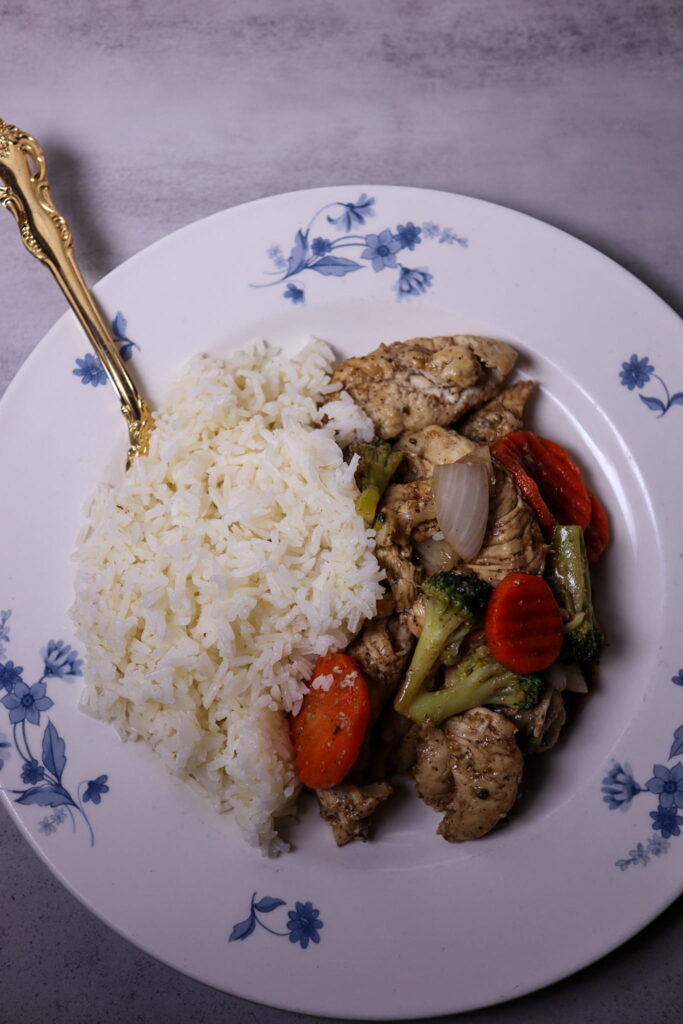 Chicken stir-fry served with white rice.