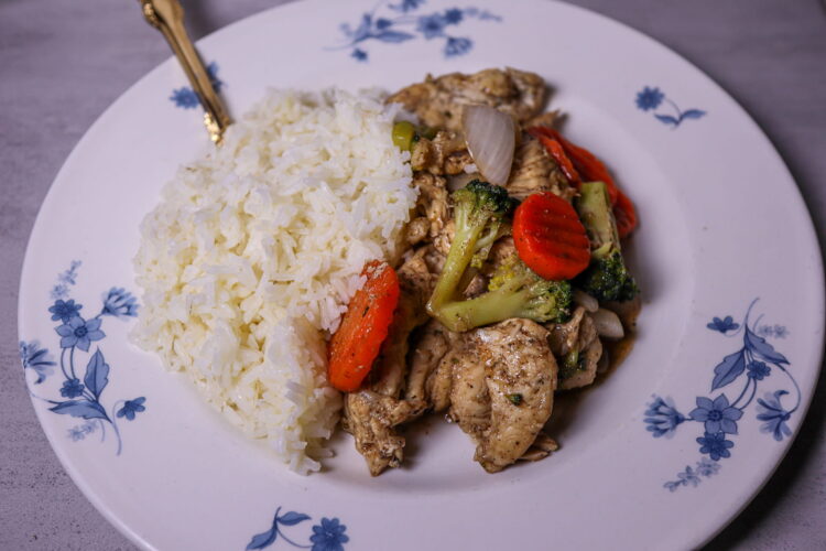 Chicken stir-fry served with white rice.