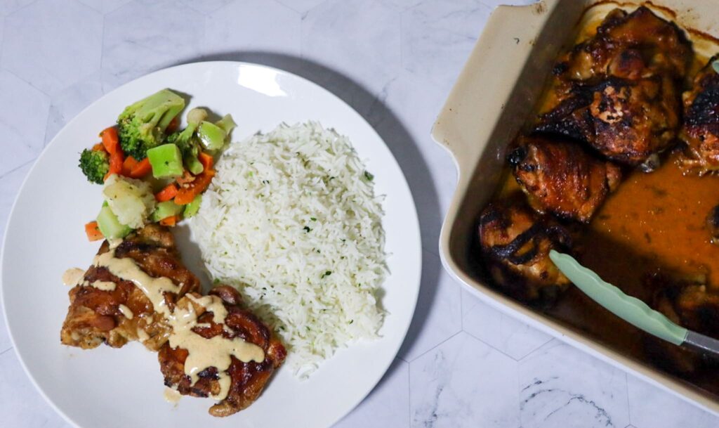 Crispy BBQ chicken with Alabama white BBQ sauce servedwith parsley rice and mixed vegetables.